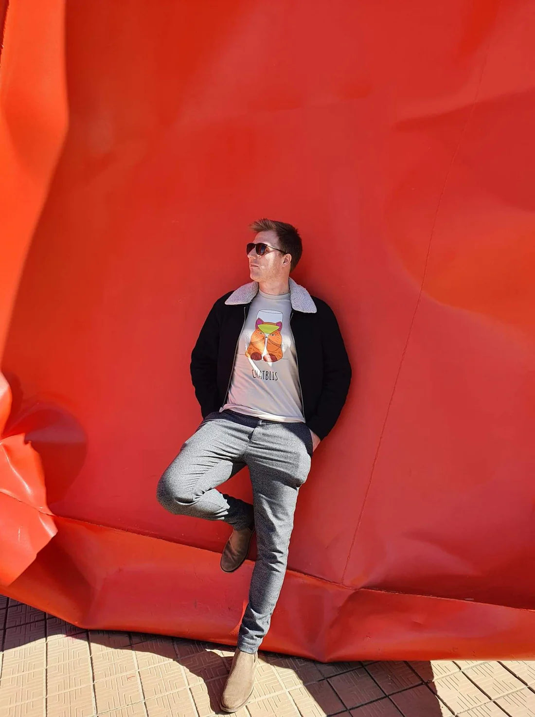 Man draagt PH Designs Chatblis T-shirt tegen rode achtergrond